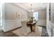 Bright dining room features classic wainscoting, a stylish chandelier, and a table for Gathering gatherings at 130 Summerhill Dr # 16, Mooresville, NC 28115