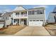 Charming two-story home featuring a stone-accented facade, a cozy front porch, and a convenient two-car garage at 130 Summerhill Dr # 16, Mooresville, NC 28115