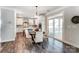 Kitchen and dining area featuring modern light fixtures, sliding glass doors, and an open floor plan at 130 Summerhill Dr # 16, Mooresville, NC 28115