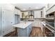 Modern kitchen showcasing a central island with counter seating and stainless steel appliances at 130 Summerhill Dr # 16, Mooresville, NC 28115