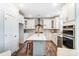 Modern kitchen with white cabinetry, stainless steel appliances, and a spacious center island at 130 Summerhill Dr # 16, Mooresville, NC 28115