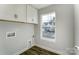 Well-lit laundry room with cabinets and a window with view of the neighborhood at 130 Summerhill Dr # 16, Mooresville, NC 28115