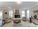Bright living room featuring a modern fireplace, large windows, and comfortable seating at 130 Summerhill Dr # 16, Mooresville, NC 28115