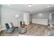 Spacious room with wood flooring, stylish seating, and abundant natural light at 130 Summerhill Dr # 16, Mooresville, NC 28115