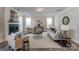 Spacious living room with a cozy fireplace, stylish decor, and plenty of natural light for comfortable living at 130 Summerhill Dr # 16, Mooresville, NC 28115
