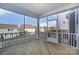 Covered screened-in porch with wood flooring, white railings and views of backyard at 130 Summerhill Dr # 16, Mooresville, NC 28115