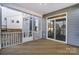 Spacious screened-in porch with wood flooring, white railings and sliding glass door at 130 Summerhill Dr # 16, Mooresville, NC 28115