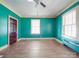 Spacious bedroom with teal walls and hardwood floors at 5237 Nc Highway 90 E Hwy, Hiddenite, NC 28636