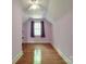 Purple bedroom with hardwood floors and window at 5237 Nc Highway 90 E Hwy, Hiddenite, NC 28636