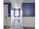 Small bedroom with blue walls and a window at 5237 Nc Highway 90 E Hwy, Hiddenite, NC 28636