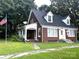 Brick home with front porch and American flag at 5237 Nc Highway 90 E Hwy, Hiddenite, NC 28636