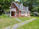 Brick home with front porch, stone steps, and landscaped lawn at 5237 Nc Highway 90 E Hwy, Hiddenite, NC 28636