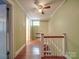 Light green hallway with hardwood floors and staircase at 5237 Nc Highway 90 E Hwy, Hiddenite, NC 28636