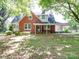 Brick house with covered porch and landscaping at 5237 Nc Highway 90 E Hwy, Hiddenite, NC 28636
