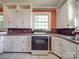 White kitchen cabinets and a brick backsplash at 5237 Nc Highway 90 E Hwy, Hiddenite, NC 28636