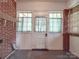 Laundry area with brick walls, white door and window coverings at 5237 Nc Highway 90 E Hwy, Hiddenite, NC 28636