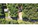 Aerial view of a house and lot next to a road in a wooded area at 248 Pioneer Dr # 990, Mount Gilead, NC 27306