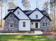 Two-story home with stone and white siding, a black roof and a front porch at 248 Pioneer Dr # 990, Mount Gilead, NC 27306