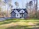 Two-story house with gray stone and white siding, nestled in a wooded setting at 248 Pioneer Dr # 990, Mount Gilead, NC 27306