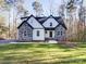 Two-story home with stone and white siding, situated on a wooded lot at 248 Pioneer Dr # 990, Mount Gilead, NC 27306