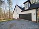 Two-story home with a two-car garage, stone and white accents, near a lake at 248 Pioneer Dr # 990, Mount Gilead, NC 27306