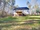 White house exterior with deck and stairs at 248 Pioneer Dr # 990, Mount Gilead, NC 27306