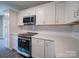 Modern kitchen with white cabinets and teal appliances at 248 Pioneer Dr # 990, Mount Gilead, NC 27306