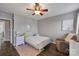 Comfortable bedroom featuring hardwood floors, neutral walls, and soft natural lighting at 17615 Trolley Crossing Way, Cornelius, NC 28031