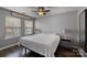 Bright bedroom featuring hardwood floors, neutral walls, and a ceiling fan at 17615 Trolley Crossing Way, Cornelius, NC 28031