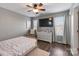 Cozy bedroom with dark hardwood floors, neutral walls, and a ceiling fan at 17615 Trolley Crossing Way, Cornelius, NC 28031