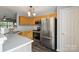 Kitchen with stainless steel appliances, light wood cabinets, and light countertops at 17615 Trolley Crossing Way, Cornelius, NC 28031