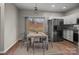 Bright dining room features wood floors, modern table set, and stainless steel refrigerator at 124 Rapids Rd, Fort Mill, SC 29715