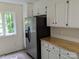 Kitchen with stainless steel refrigerator and butcher block countertops at 4939 Lailwood Cir, Charlotte, NC 28227