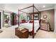 Spacious main bedroom with a four poster bed and en-suite bathroom access at 11732 Kennewick Rd, Charlotte, NC 28216