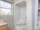 Bathroom featuring a shower unit, neutral walls, and a window providing natural light at 553 Georgia Ave, Statesville, NC 28677