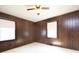 Spacious bedroom with two windows, ceiling fan, paneled walls and carpeted floor at 553 Georgia Ave, Statesville, NC 28677
