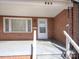 View of the front porch showing a brick facade and a white front door at 553 Georgia Ave, Statesville, NC 28677