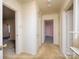 Hallway with carpet and multiple doors and a glimpse into a pink bedroom at 553 Georgia Ave, Statesville, NC 28677