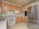 Traditional kitchen showcasing wooden cabinets, stainless steel appliances and ample countertop space at 553 Georgia Ave, Statesville, NC 28677