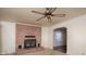 Cozy living room featuring a brick fireplace and a decorative ceiling fan at 553 Georgia Ave, Statesville, NC 28677