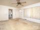 Bright living room with neutral carpet, ceiling fan and multiple access doors at 553 Georgia Ave, Statesville, NC 28677