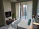 This staged bedroom features a plush bed, balcony access, and modern decor for a comfortable retreat at 701 Royal Ct # 309, Charlotte, NC 28202