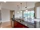 Kitchen island with granite countertops and double sink, overlooking balcony at 701 Royal Ct # 309, Charlotte, NC 28202