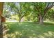 Large backyard with mature trees and storage shed at 621 Oak Grove Rd, Kings Mountain, NC 28086