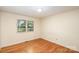 Simple bedroom with hardwood floors and large windows at 621 Oak Grove Rd, Kings Mountain, NC 28086