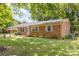 Side view of brick ranch house with light blue shutters and landscaping at 621 Oak Grove Rd, Kings Mountain, NC 28086