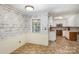 Kitchen with wood-like wallpaper and white cabinets needs updating at 621 Oak Grove Rd, Kings Mountain, NC 28086