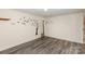 Empty living room with wood-look floors and wall decals at 621 Oak Grove Rd, Kings Mountain, NC 28086