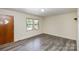 Living room with wood-look floors, a door, and windows at 621 Oak Grove Rd, Kings Mountain, NC 28086