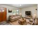 Furnished living room with wood-look floors and a large TV at 621 Oak Grove Rd, Kings Mountain, NC 28086